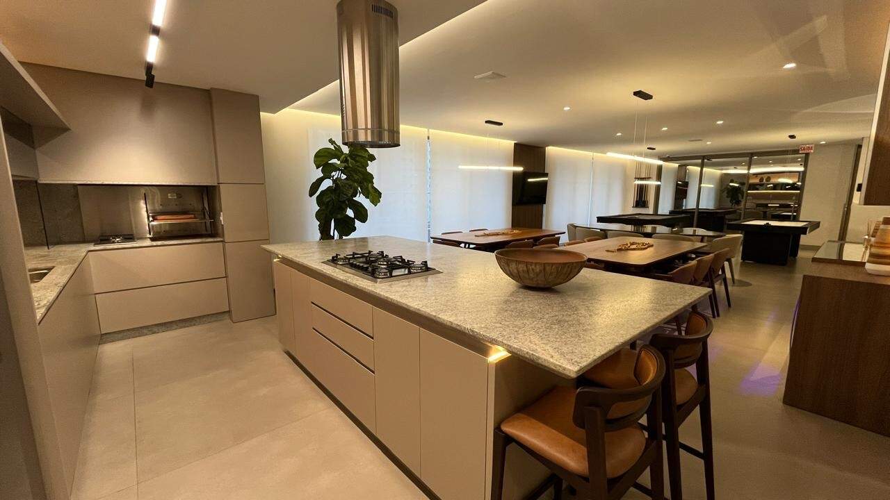 Cozinha do espaço gourmet com ilha, cooktop e churrasqueira