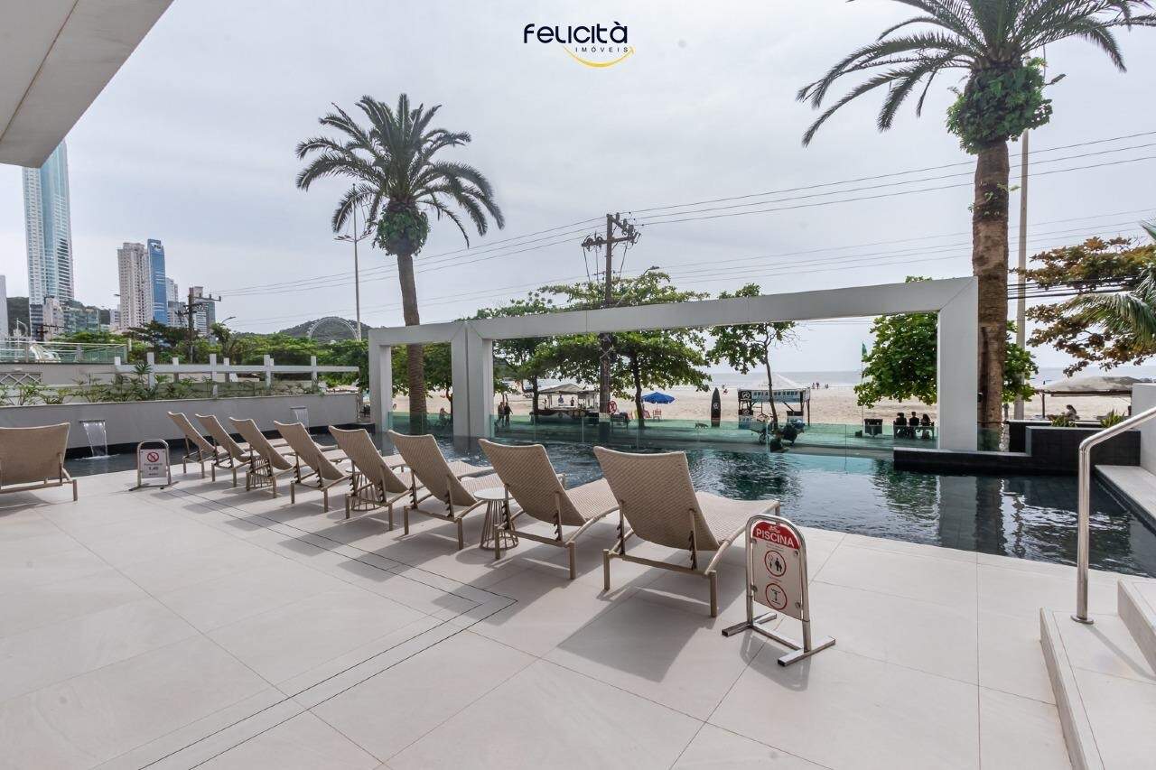 Piscina frontal com deck, espreguiçadeiras e vista para a praia