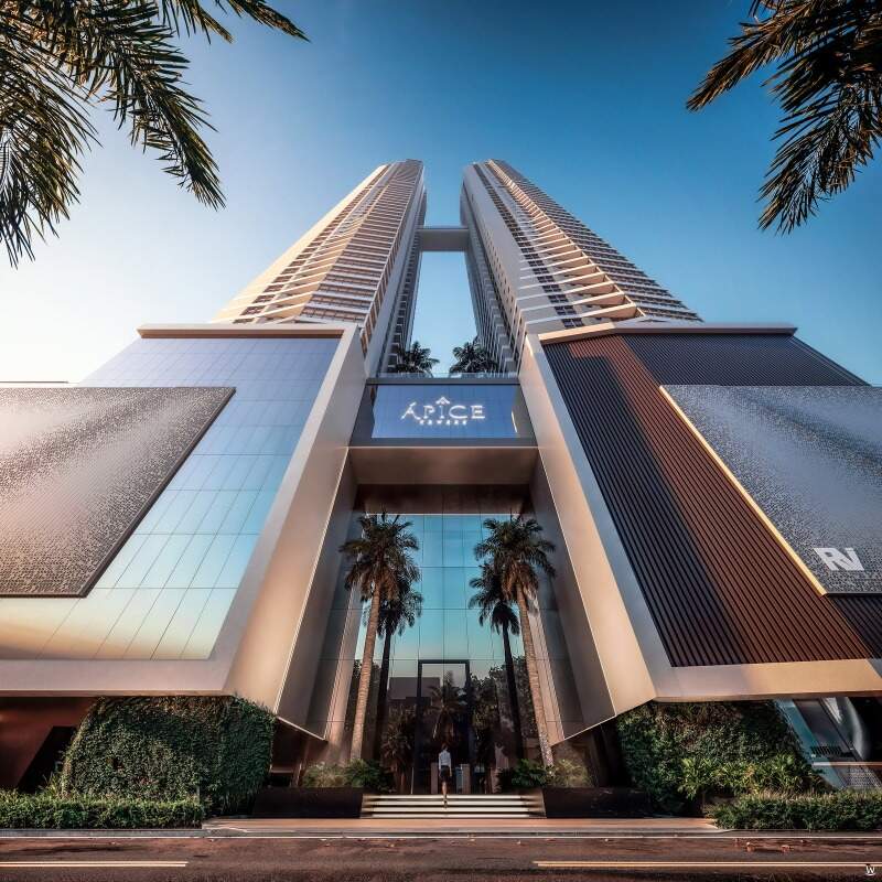 Entrada do Ápice Towers, com palmeiras e o nome do prédio no embasamento (imagem ilustrativa)