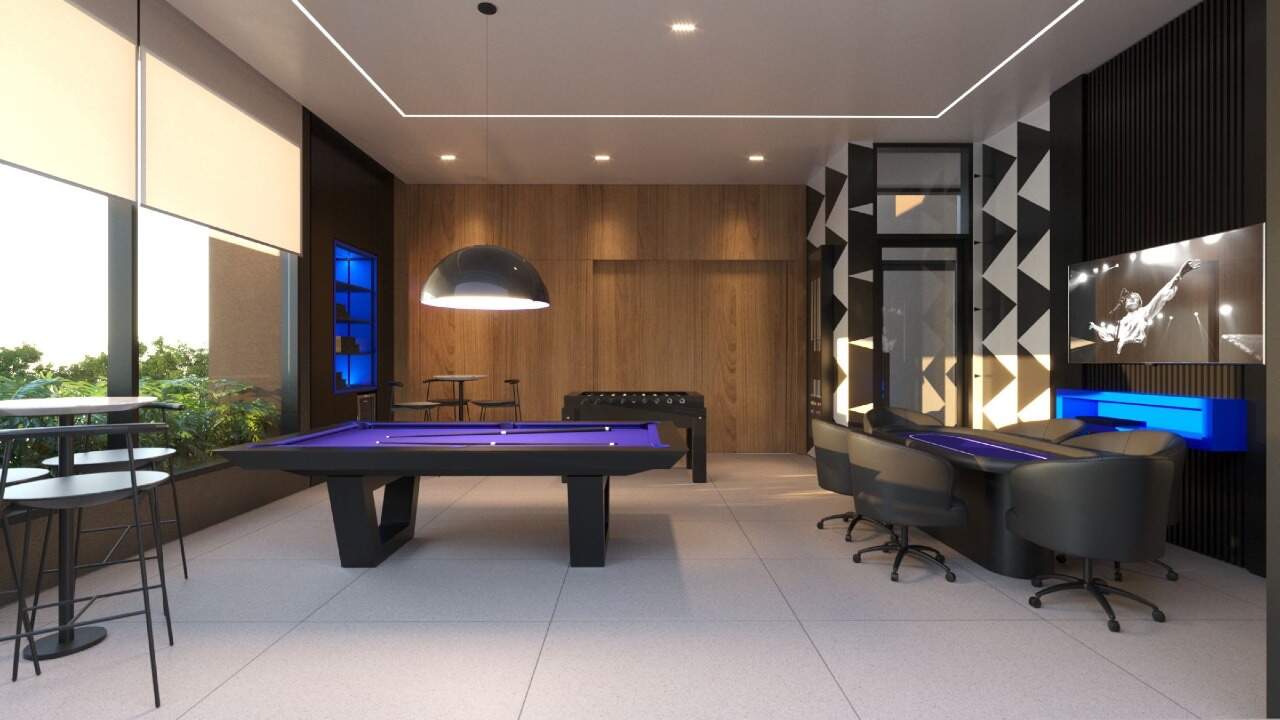 Sala de jogos com mesa de sinuca e mesa de carteado (imagem ilustrativa)