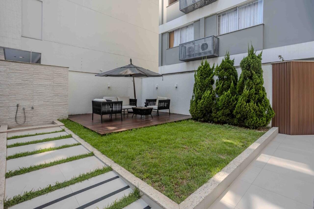 Jardim com gramado e deck de madeira