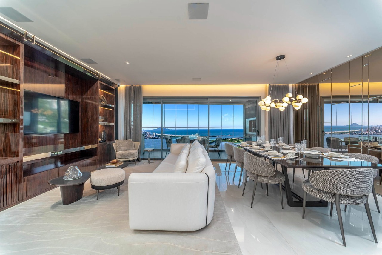 Living e jantar do apartamento decorado de 4 suítes, com vista para a água