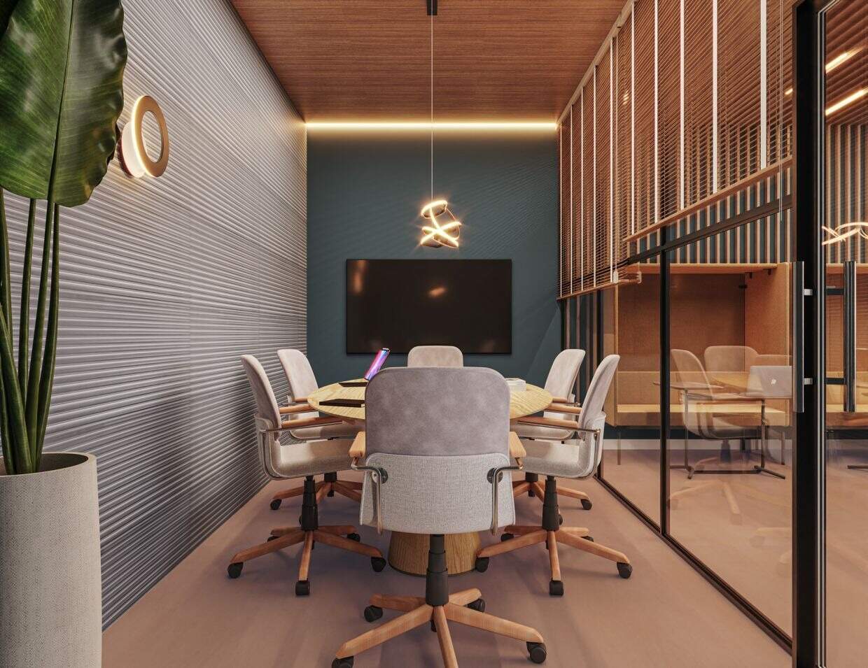 Sala de reunião do coworking, com mesa redonda e TV (imagem ilustrativa)