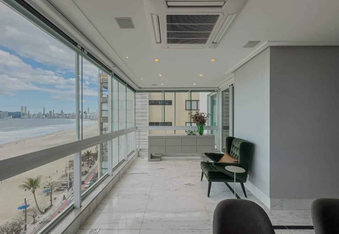 Apartamento à venda no Centro: Sacada envidraçada com estar e vista lateral para a orla