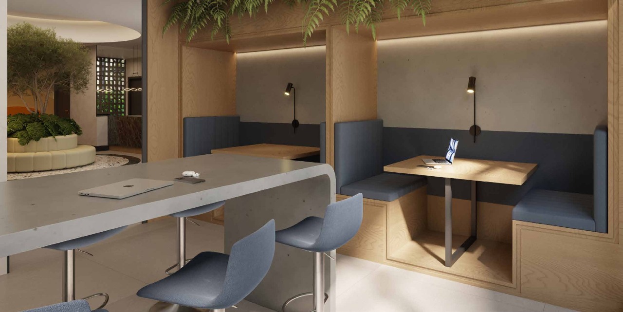 Apartamento à venda no Centro: Coworking do térreo, com mesas compartilhadas e cabines (imagem ilustrativa)