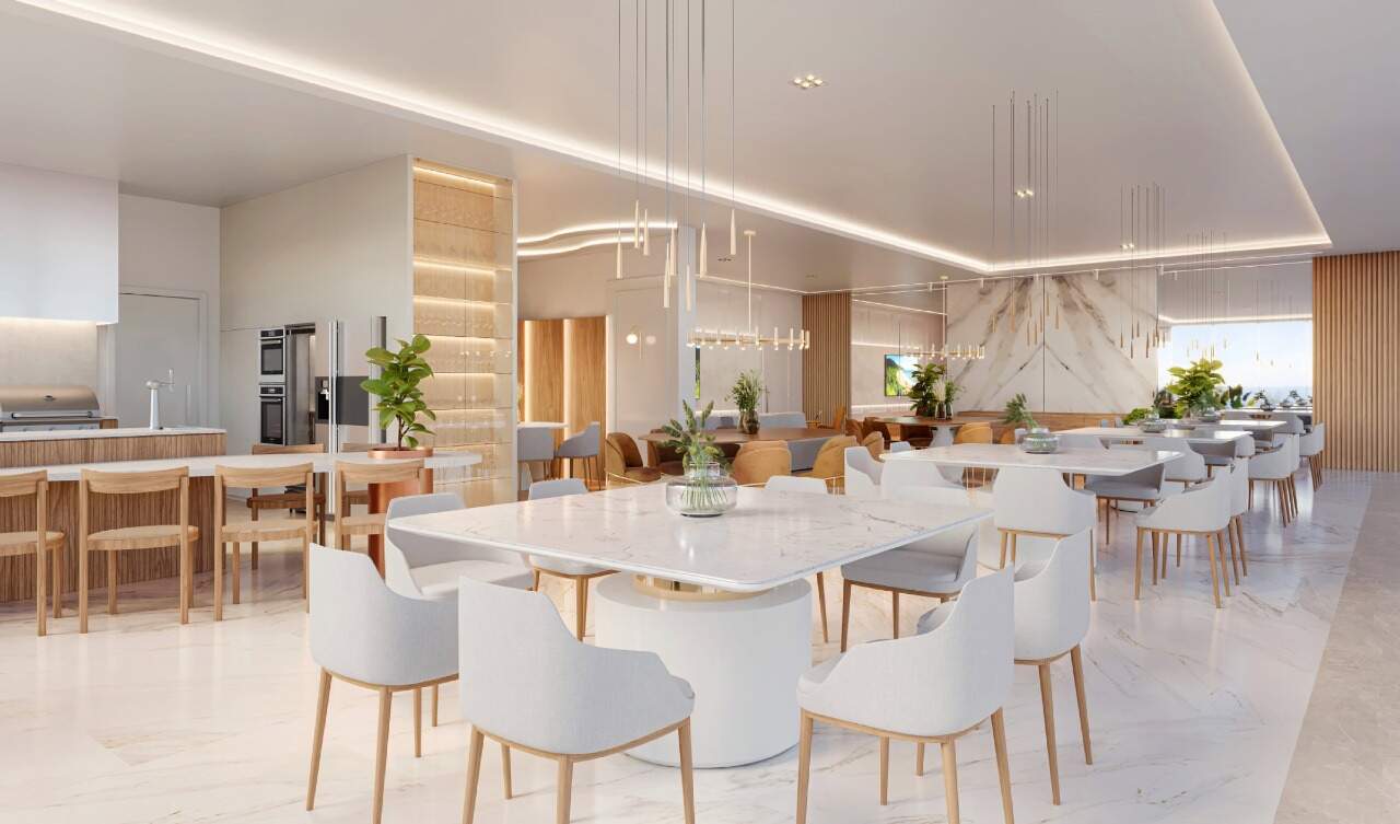 Apartamento diferenciado à venda no Centro: Salão de festas com mesas de mármore e cozinha de apoio (imagem ilustrativa)
