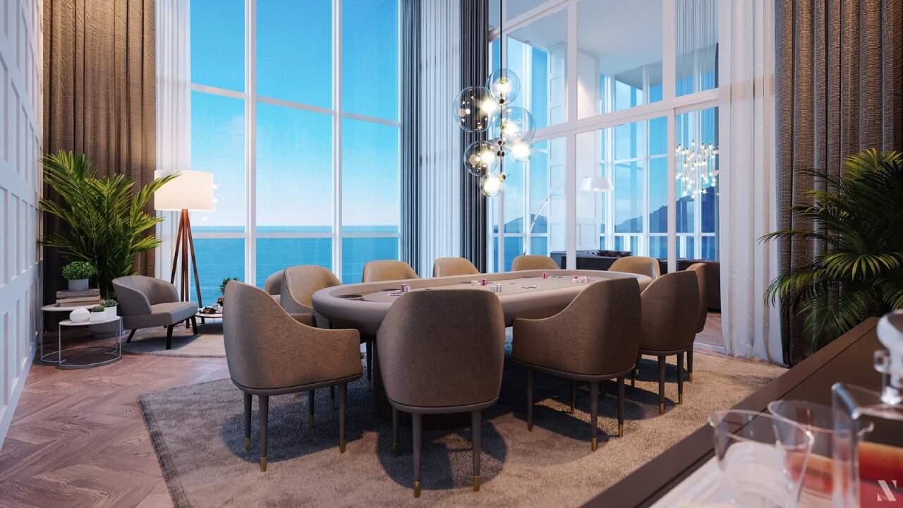 Apartamento diferenciado à venda no Centro: Sala de jogos com mesa de carteado e vista para o mar (imagem ilustrativa)