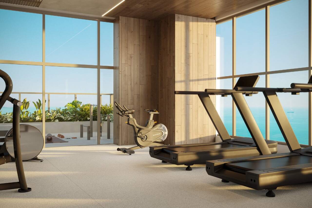 Apartamento à venda no Pioneiros: Esteiras e bicicleta da academia, com vista para o mar (imagem ilustrativa)