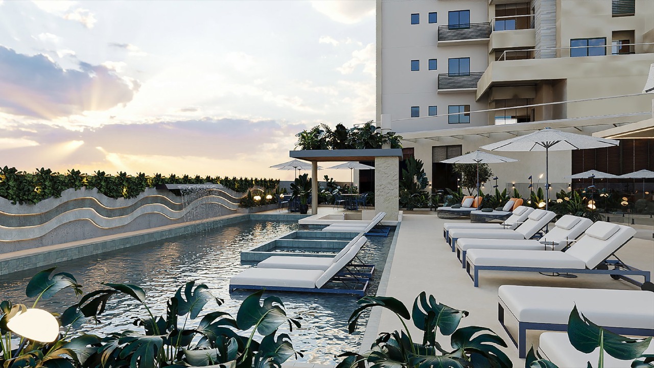 Apartamento à venda no Pioneiros: Piscina principal com prainha e espreguiçadeiras (imagem ilustrativa)