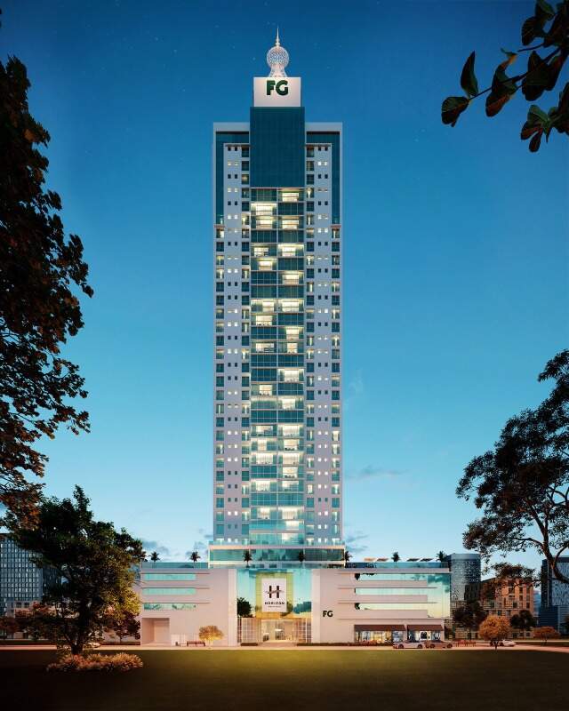 Apartamento à venda no Centro: Torre do Horizon Residence iluminada à noite (imagem ilustrativa)