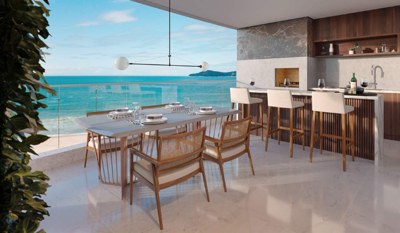 Apartamento à venda no Praia Brava: Espaço gourmet com mesa de jantar e vista para o mar (imagem ilustrativa)