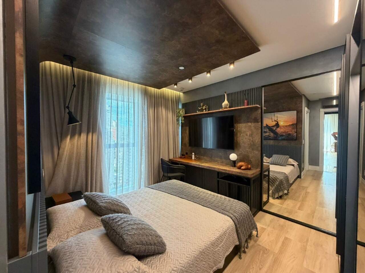 Apartamento à venda no Barra Sul: Suíte com forro escuro, painel de TV e escrivaninha