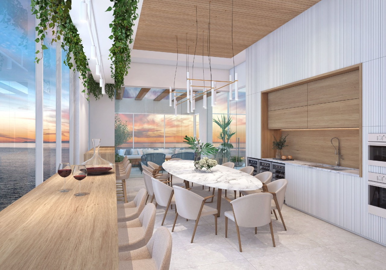 Apartamento à venda no Pioneiros: Sunset Wine no rooftop do Blue Coast Tower, com o mar ao entardecer (imagem ilustrativa)