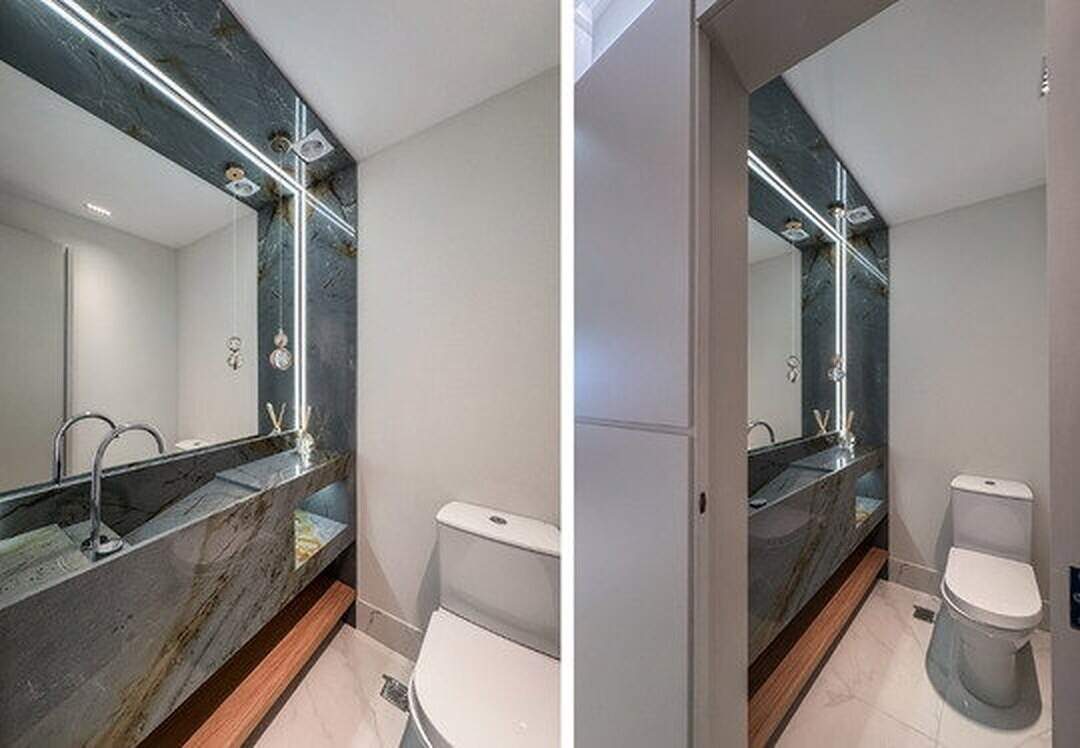 Apartamento à venda no Pioneiros: Lavabo com bancada de pedra e espelho iluminado