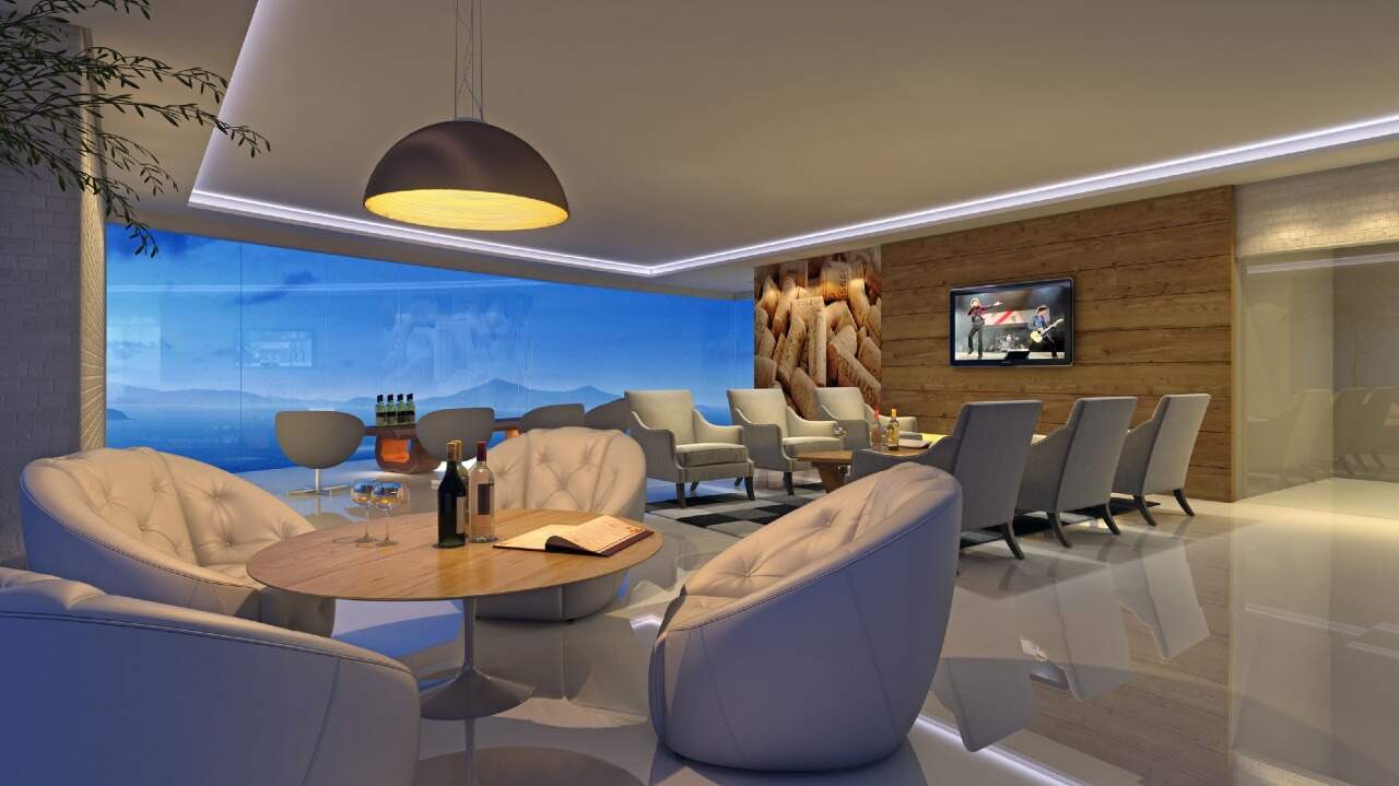 Apartamento à venda no Barra Sul: Espaço gourmet com poltronas e vista para o mar (imagem ilustrativa)