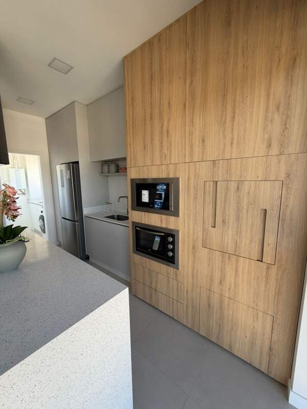 Apartamento à venda no Praia Brava: Cozinha com armários planejados, fornos embutidos e geladeira