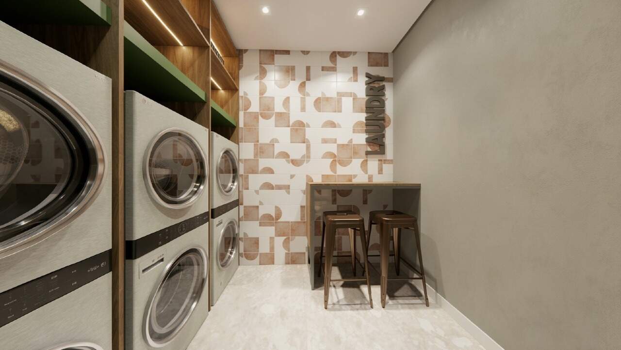 Apartamento diferenciado à venda no Centro: Lavanderia compartilhada com lavadoras e secadoras empilhadas (imagem ilustrativa)