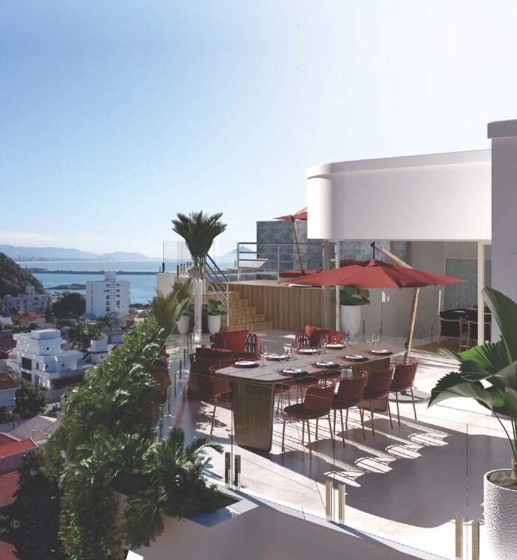 Cobertura à venda no Cabeçudas: Terraço da cobertura de 291 m² com mesa de jantar e o mar ao fundo (imagem ilustrativa)