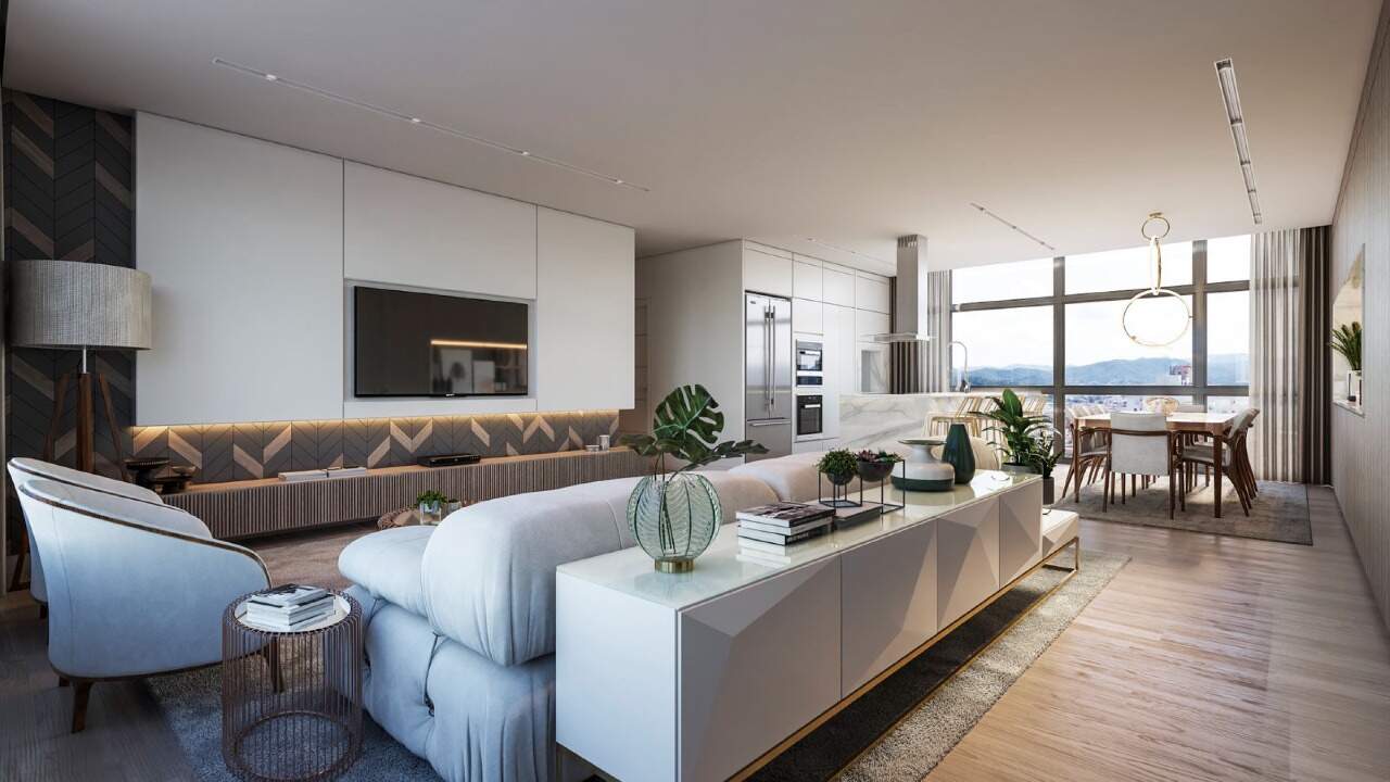 Apartamento à venda no Centro: Living com sofá e cozinha integrada ao fundo (imagem ilustrativa)
