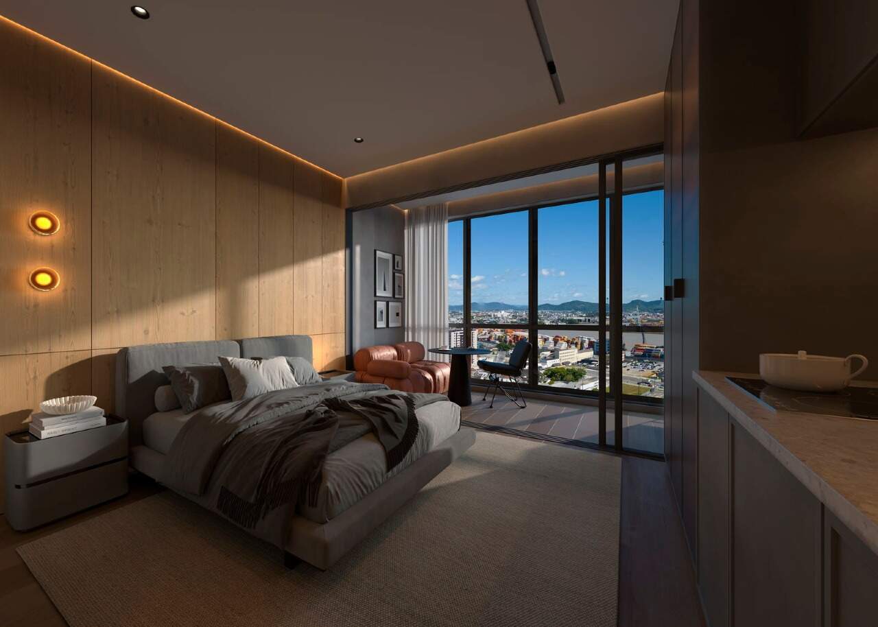Apartamento à venda no Centro: Studio decorado com cama e sacada (imagem ilustrativa)