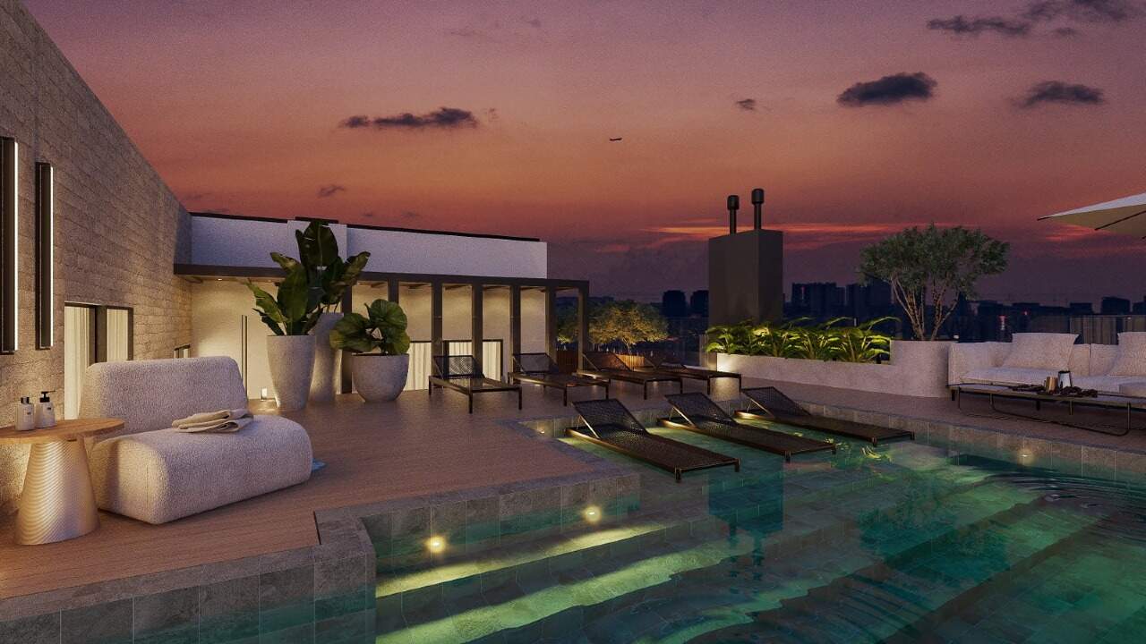 Apartamento à venda no Centro: Rooftop com piscina ao entardecer (imagem ilustrativa)